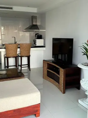 a living room with a flat screen tv on a entertainment center at Ocean View Residences! in Karon Beach