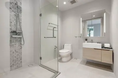 a bathroom with a shower and a toilet and a sink at Diamond Resort in Bang Tao Beach