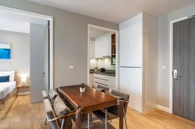 a kitchen and dining room with a table and chairs at Diamond Resort in Bang Tao Beach