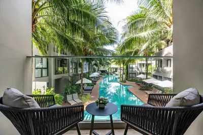 a view of the pool from the balcony of a resort at Diamond Resort in Bang Tao Beach