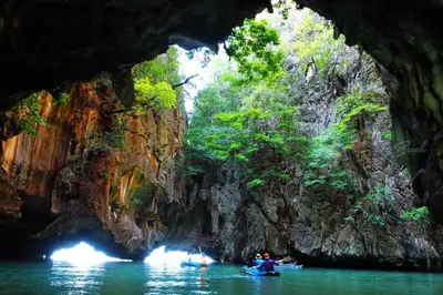 a group of people kayaking in a cave at Вилла Boutique Pool Villa с 3 спальнями in Ban Saiyuan (1)