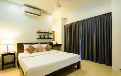 a bedroom with a large bed with a black curtain at Вилла Boutique Pool Villa с 3 спальнями in Ban Saiyuan (1)