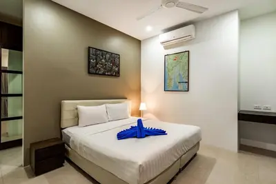 a bedroom with a bed with a blue tray on it at West facing 3br Boutique Pool Villa in Phuket Town
