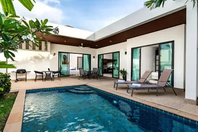 a house with a swimming pool and a patio at West facing 3br Boutique Pool Villa in Phuket Town