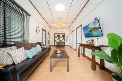 a living room with a couch and a table at Rawai Cottage House in Rawai Beach