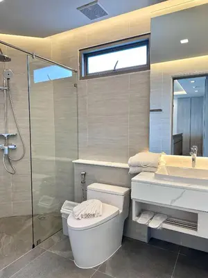 a bathroom with a toilet and a sink and a shower at The Regent Phuket Bangtao Beach in Bang Tao Beach