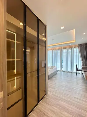a room with a glass partition with a bedroom in the background at The Regent Phuket Bangtao Beach in Bang Tao Beach