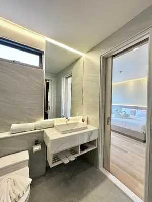 a bathroom with a sink and a large mirror at The Regent Phuket Bangtao Beach in Bang Tao Beach