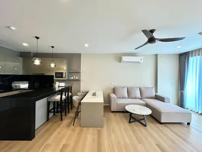 a living room and kitchen with a couch and a table at The Regent Phuket Bangtao Beach in Bang Tao Beach