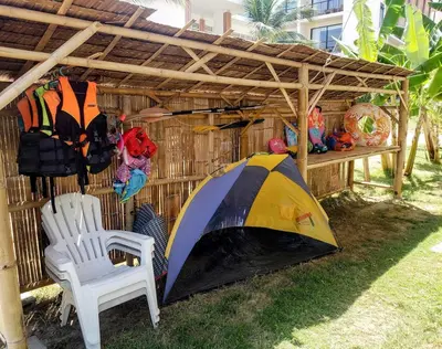 a tent and a chair under a wooden shed at Beach Front Sand Castle - kid friendly right on the perfect beach in Ban Ao Makham