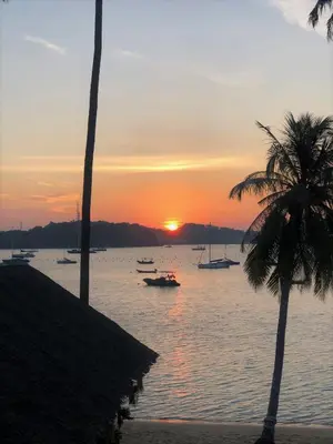 a sunset over a body of water with boats at Beach Front Sand Castle - kid friendly right on the perfect beach in Ban Ao Makham