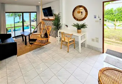 a living room with a table and chairs at Beach Front Sand Castle - kid friendly right on the perfect beach in Ban Ao Makham