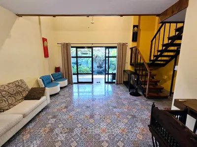 a living room with a couch and a staircase at Baibon 4 Homestay Thalang Phuke in Thalang