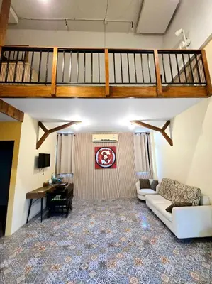 a large living room with a couch and a desk at Baibon 4 Homestay Thalang Phuke in Thalang