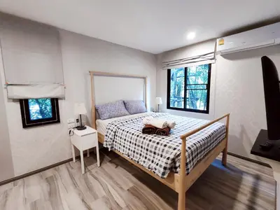 a bedroom with a bed with a bag on it at Title Residencies Naiyang 2 Bedrooms PoolAccess in Nai Yang Beach