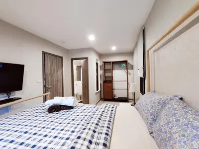 a dog laying on a bed in a bedroom at Title Residencies Naiyang 2 Bedrooms PoolAccess in Nai Yang Beach