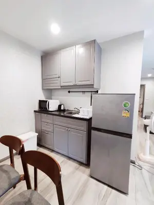a kitchen with a stainless steel refrigerator and cabinets at Title Residencies Naiyang 2 Bedrooms PoolAccess in Nai Yang Beach