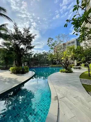 a swimming pool with blue water in a building at Title Residencies Naiyang 2 Bedrooms PoolAccess in Nai Yang Beach