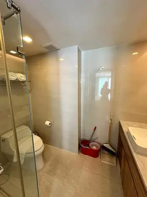 a bathroom with a toilet and a glass shower at HomeAwayFromHome in Phuket Town