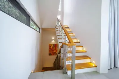 a staircase in a house with yellow steps at Lapista 6 Bedroom Luxury Vila in Phuket Town