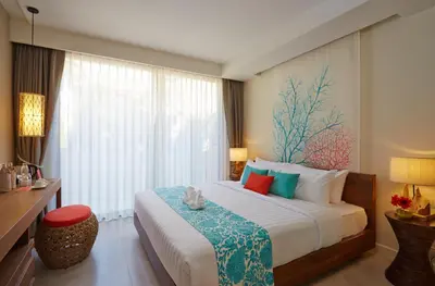 a bedroom with a large bed and a window at Bandara Beach Resort, Phuket in Panwa Beach