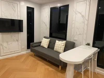 a living room with a couch and a table at Little Sweet Home in Phuket Town