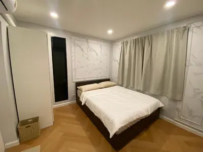 a small bedroom with a bed and a window at Little Sweet Home in Phuket Town