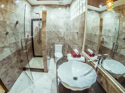 a bathroom with a sink and a shower and a toilet at Baan Sung Apartments in Kamala Beach