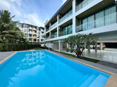 an image of a swimming pool in front of a building at Seaside Naithon Phuket - Newly Opened in Nai Thon Beach