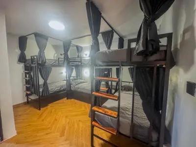 a room with four bunk beds and a wooden floor at Nordic Hostel I Female Only I Dorms only in Phi Phi Don