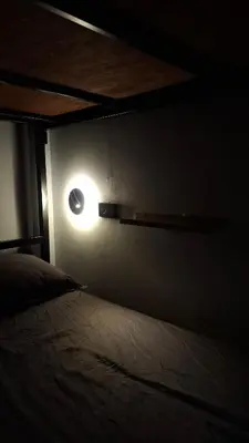 a room with a bed and a light on the wall at Nordic Hostel I Female Only I Dorms only in Phi Phi Don