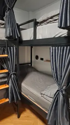 a couple of bunk beds with curtains on them at Nordic Hostel I Female Only I Dorms only in Phi Phi Don