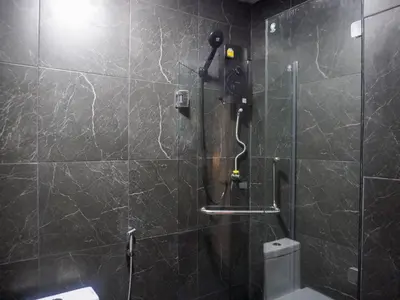 a bathroom with a shower with a glass door at Nordic Hostel I Female Only I Dorms only in Phi Phi Don