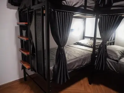 a bedroom with two bunk beds with curtains at Nordic Hostel I Female Only I Dorms only in Phi Phi Don