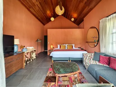 a hotel room with a bed and a couch at Niran Farm in Koh Lone