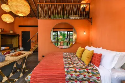 a bed in a room with an orange wall at Niran Farm in Koh Lone