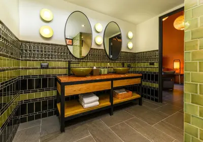 a bathroom with two sinks and mirrors on the wall at Niran Farm in Koh Lone
