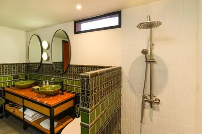 a bathroom with two sinks and a shower at Niran Farm in Koh Lone