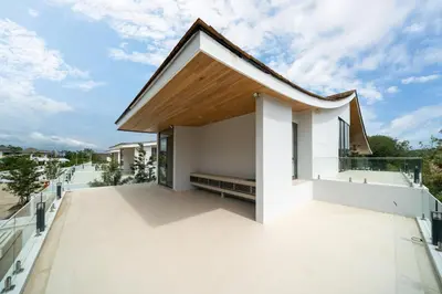 a white house with a wooden roof at Modern Masterpiece with Tropical Flair! 5BR Villa Trinity C4 in Bang Tao Beach