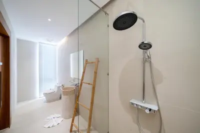 a bathroom with a shower with a glass door at Modern Masterpiece with Tropical Flair! 5BR Villa Trinity C4 in Bang Tao Beach