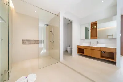 a bathroom with a glass shower and a sink at Modern Masterpiece with Tropical Flair! 5BR Villa Trinity C4 in Bang Tao Beach