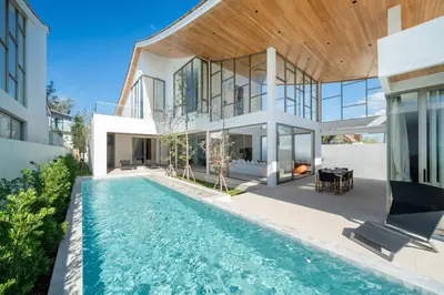 an exterior view of a house with a swimming pool at Trendy & Minimalist Design 5BR Pool Villa Trinity C1 in Bang Tao Beach