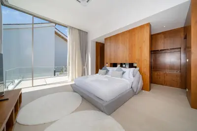 a bedroom with a large bed and a large window at Trendy & Minimalist Design 5BR Pool Villa Trinity C1 in Bang Tao Beach