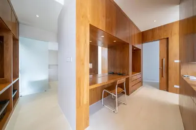 a dressing room with wooden cabinets and a desk at Trendy & Minimalist Design 5BR Pool Villa Trinity C1 in Bang Tao Beach