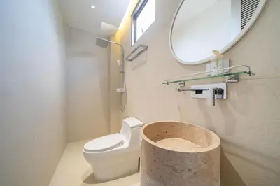 a bathroom with a toilet and a mirror and a sink at Trendy & Minimalist Design 5BR Pool Villa Trinity C1 in Bang Tao Beach