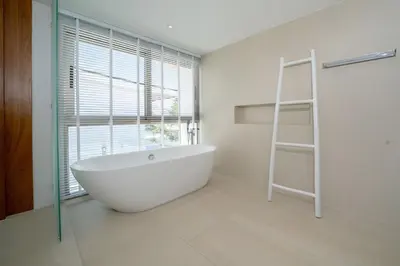 a bathroom with a white bath tub and a ladder at Brand-New & Luxury 5BR Pool Villa Trinity C2 in Bang Tao Beach