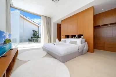 a bedroom with a large white bed and a large window at Brand-New & Luxury 5BR Pool Villa Trinity C2 in Bang Tao Beach