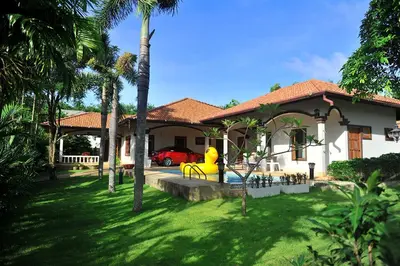 a house with a yellow fire hydrant in the yard at Kesorn Charming Authentic Thai Pool Villa Phuket in Rawai Beach