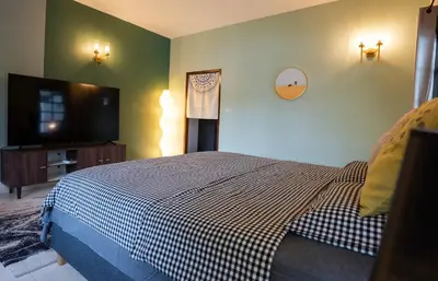 a bedroom with a bed and a flat screen tv at Kesorn Charming Authentic Thai Pool Villa Phuket in Rawai Beach