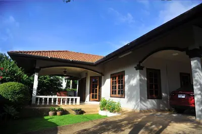 a house with a car parked in front of it at Kesorn Charming Authentic Thai Pool Villa Phuket in Rawai Beach